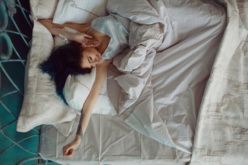 Woman stretching in bed after wake up