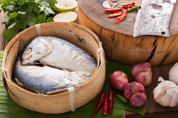 steamed mackerel in  bamboo basket, ready for cooking in Asian kitchen