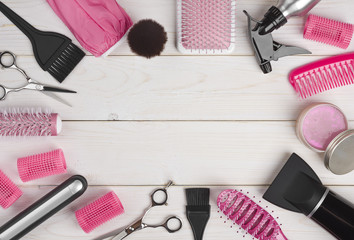 Hairdressing tools on wooden planks background with copyspace in centre