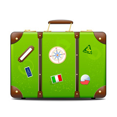 Green suitcase with stickers on surface
