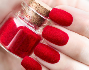 Velvet nails. Fashion trendy red fluffy nailart design closeup
