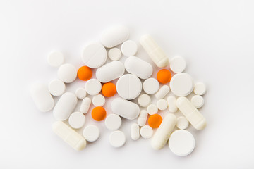 Different colored tablets on a white background close