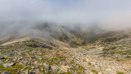 Rocky slopes in the mountains. Amazing view at the peaks which rose against the cloud sky. MOUNT FREMONT LOOKOUT TRAIL, Sunrise Area, Mount Rainier