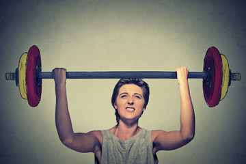 Strong woman lifting heavy barbell. Determination task completion hard work concept