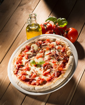 Pizza with bacon on the wooden table