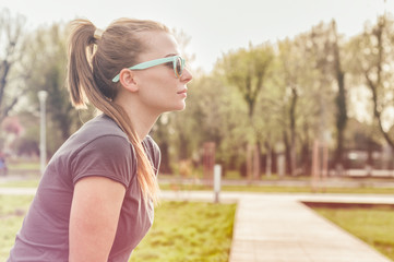 Profile of attractive young female wearing modern sunglasses