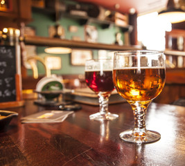 Two glasses of draught beer.