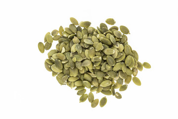 Heap of hulled pumpkin seeds, on white background