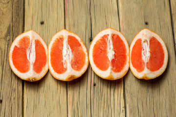 Sliced grapefruits on wooden background