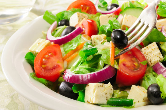 Fresh green summer salad Meditteranean with olives.