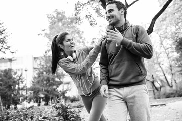 Young couple relaxing at the park,smiling and laughing.