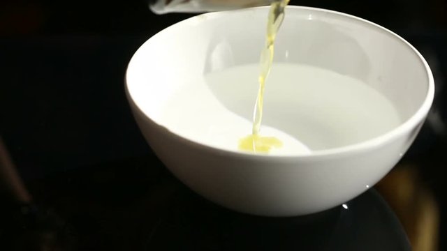 Divination with candle. woman pouring wax into the water. 