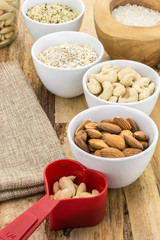Cereal grains and seeds in bowls, on wooden background