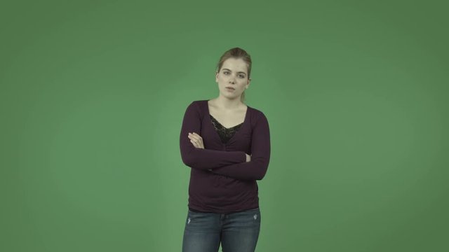 attractive casual caucasian girl isolated on green upset worried