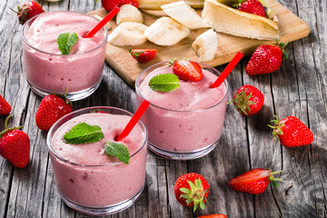 Strawberry Banana Smoothies Cups on an old rustic wooden table