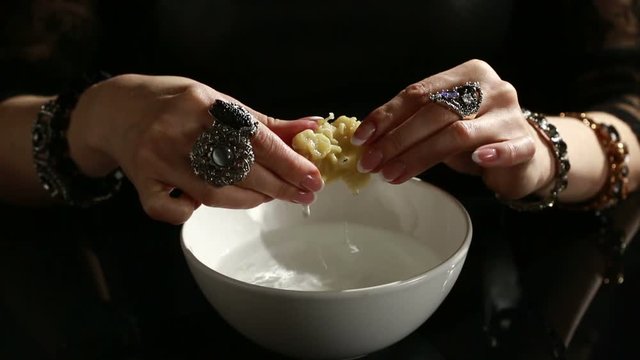 Divination with candle. woman pouring wax into the water. 