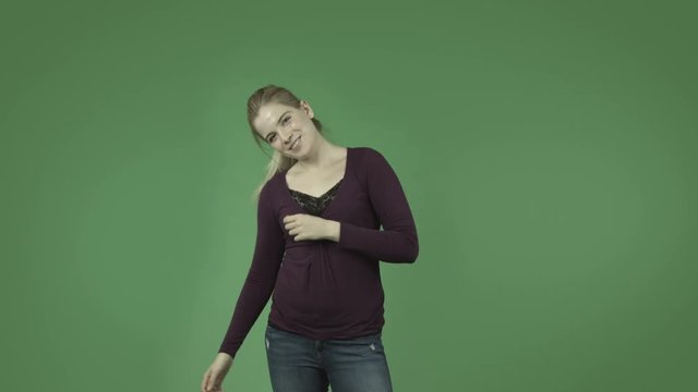 attractive casual caucasian girl isolated on green happy dance