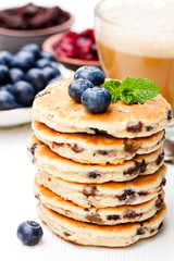 Stack  of welsh cakes with blueberry and a cup of coffee