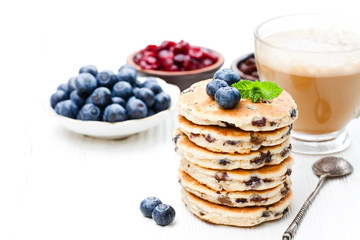 Stack  of welsh cakes with blueberry and a cup of coffee