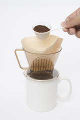 Hand holding measuring spoon coffee