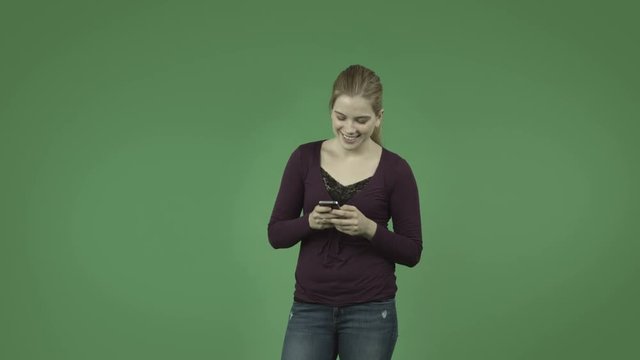 attractive casual caucasian girl isolated on green sending text email internet