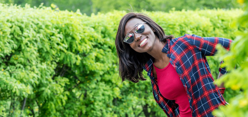 Beautiful smiling african woman outdoors in park. Fashion woman