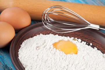 Fototapeta na wymiar Eggs, flour and egg yolk