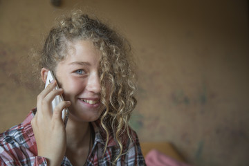 Redhead teenager talking on a mobile phone