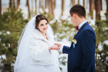 Happy bride and groom in winter day on their wedding