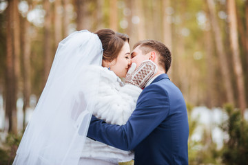 Happy bride and groom in winter day on their wedding
