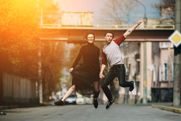 Beautiful young couple jumping
