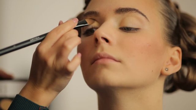 young model make-up artist paints the eyes