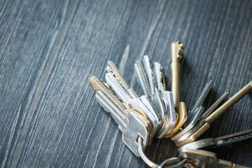 Bunch of keys with house shaped key ring on a wooden table