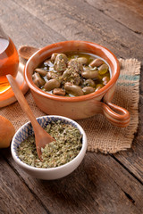 Terracotta pan with beans in unmido flavored with oregano