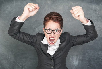 Angry screaming teacher in glasses
