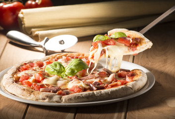 Pizza with bacon on the wooden table