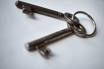 Isolated old rustic keys made of metal on the white background as a symbol of locking and unlocking