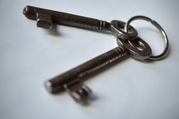 Isolated old rustic keys made of metal on the white background as a symbol of locking and unlocking