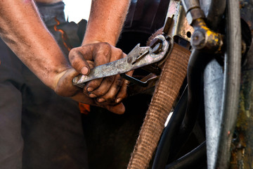 a detail of hands of dirty worker
