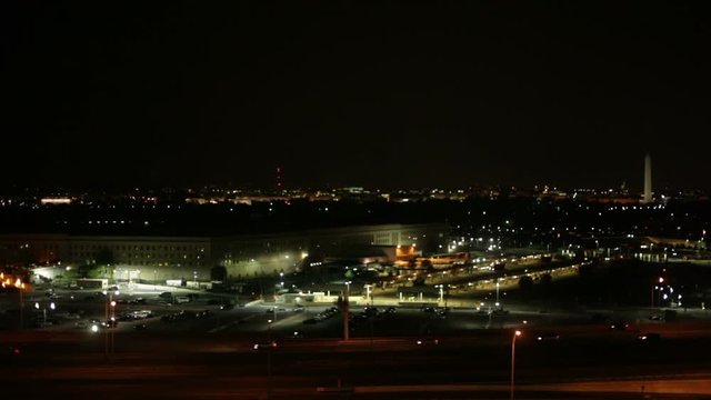 Time lapse of the Pentagon cityscape with busy highway at night in Washington DC, USA.