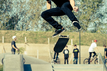 Jumps with skateboard at skatepark