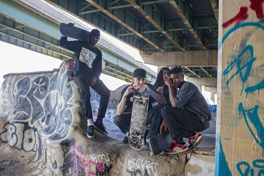 Four young men at a skateboard park.