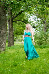 Fototapeta premium Beautiful girl, model with long hair posing in nature