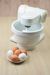Fototapeta na wymiar Blender. Whipping cream with a mixer. Eggs.Homemade baking.