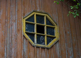 Octagonal wooden abandoned attic window