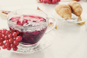 Red berries  viburnum and cup of tea
