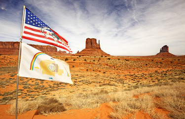 american and navajo flags waving in monument valley - obrazy, fototapety, plakaty