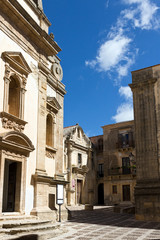 Fototapeta na wymiar Salemi - Cobbled street in historic center , Jesuit Church. Trapani province, Sicily 