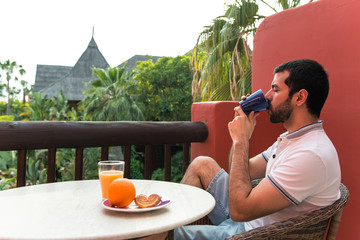 Man having breakfast on hotel terrace