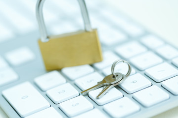 Security lock on white computer keyboard